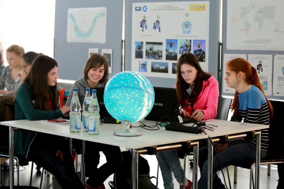 Participants of the 2015 Girls' Day at Haus der Astronomie processing astronomical images - some of which came from remote observations made by the girls themselves.