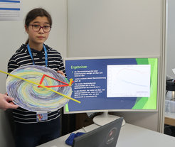 Catharina Hock with a model galaxy at the regional Nordbaden science fair.