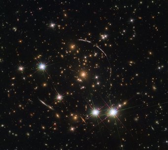Close-up of a galaxy cluster with four foreground stars surrounded by several segments of a circle Close-up of a galaxy cluster with four foreground stars surrounded by several segments of a circle