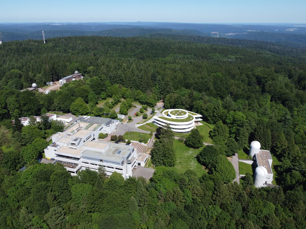 Luftaufnahme des MPIA-Campus bei wolkenlosem Himmel am 13. Juni 2021. Im Hintergrund die Landessternwarte und die auf dem Königstuhl platzierten Sendemasten.
