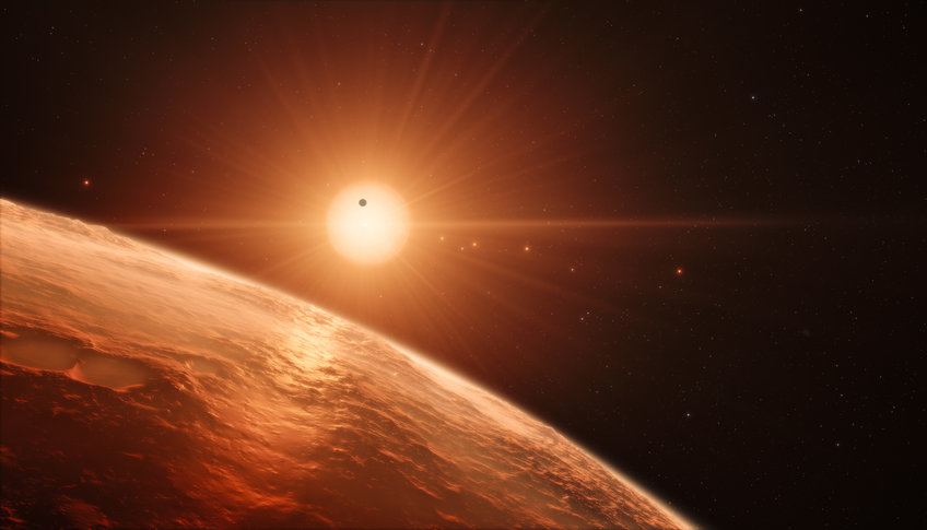Künstlerische Darstellung eines Planetensystems um einen rötlichen Stern