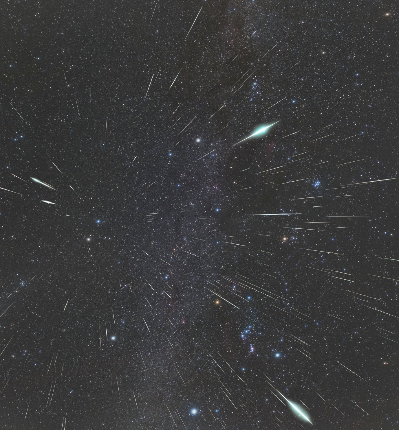 Many bright stripes in the night sky, some with a particularly bright bulge, appear to point in all directions from a point above two bright stars. The constellation Orion is at bottom right
